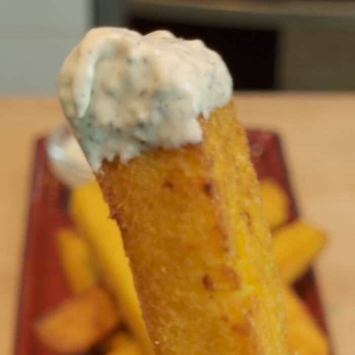 close up of fried polenta with lemon, truffle, parmesan and garlic sauce