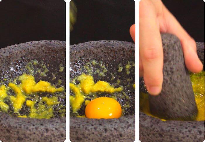 egg yolk being mixed with garlic