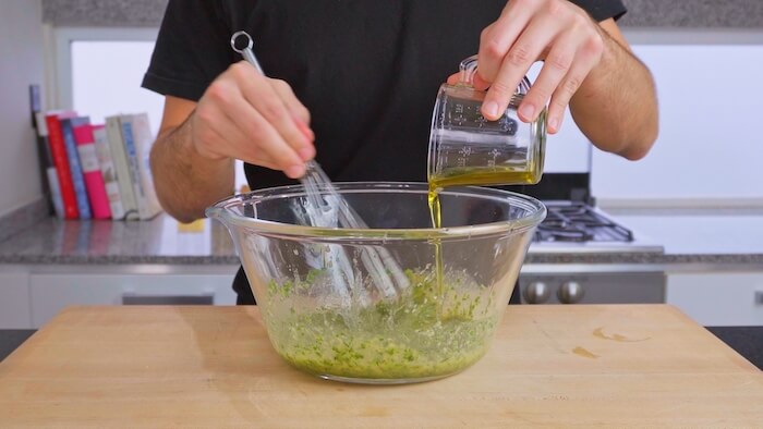 making a dressing in a bowl with extra virgin olive oil