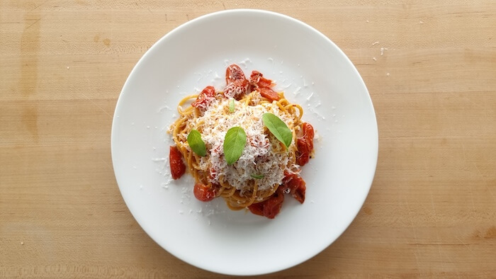 a plate of scarpariello pasta on a chopping board