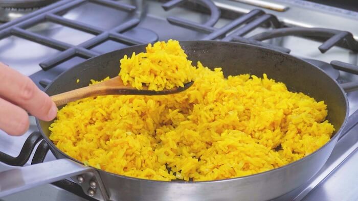 yellow rice in frying pan