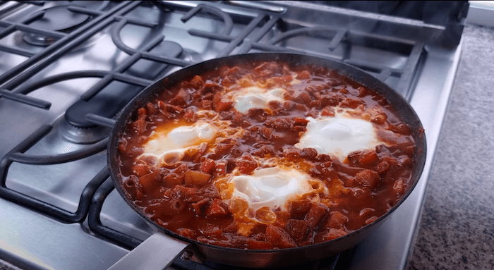 shakshuka being cooked in pan