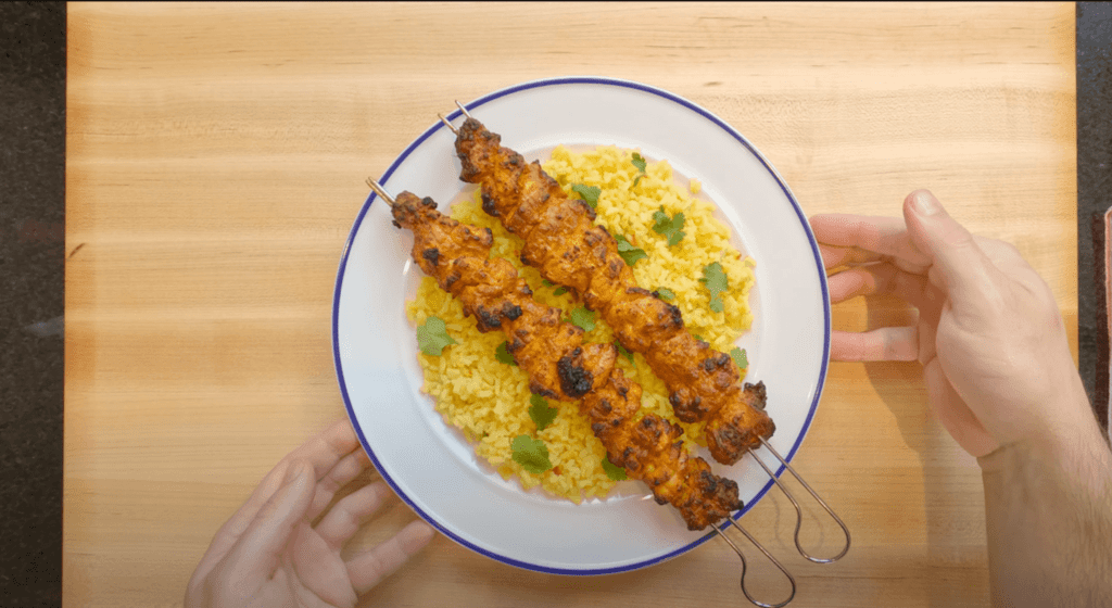 chicken tikka served with rice on a plate