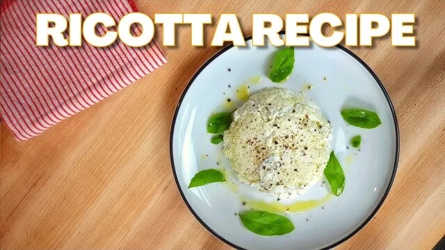 plate of ricotta cheese with olive oil and basil