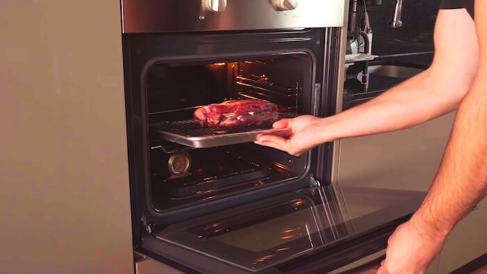 steak going into oven to reverse sear