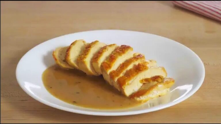 plate with sliced chicken breast and a chicken pan sauce