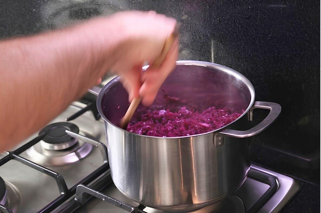 saucepan on a stove top, with red cabbage being cooked