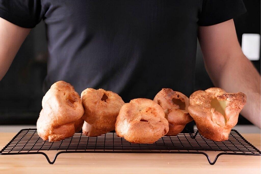 6 Yorkshire puddings cooling on a rack