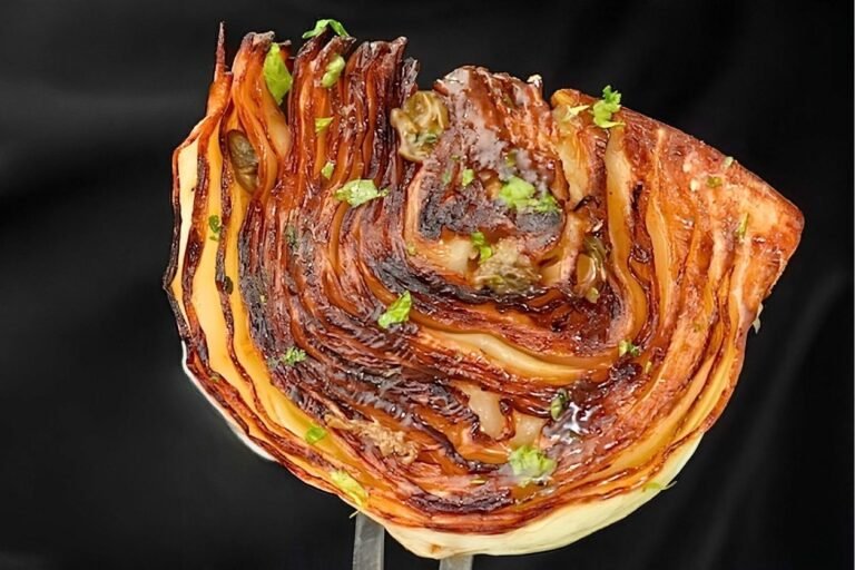 fork holding up caramelised piece of pan roasted cabbage