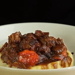 bowl of beef bourguignon and mashed potato