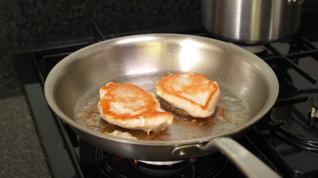 chicken-in-frying-pan-being-seared
