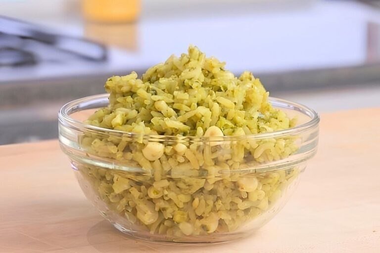 green rice in a bowl on a wooden counter top