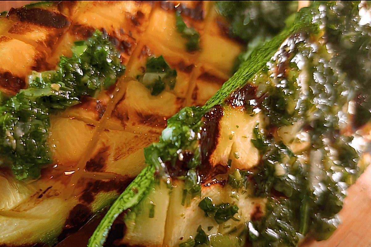 Close up of grilled courgette topped with chimichurri