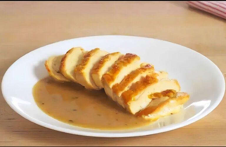 plate with sliced chicken breast and a chicken pan sauce
