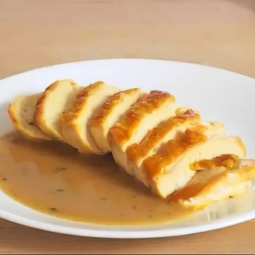 plate with sliced chicken breast and a chicken pan sauce