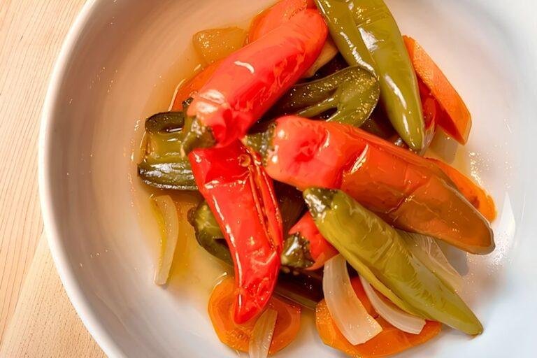 Bowl of pickled escabeche chillies with carrot and onion