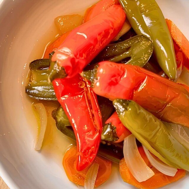 Bowl of pickled escabeche chillies with carrot and onion