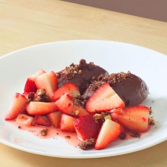 finished plate of dark chocolate mousse and strawberries