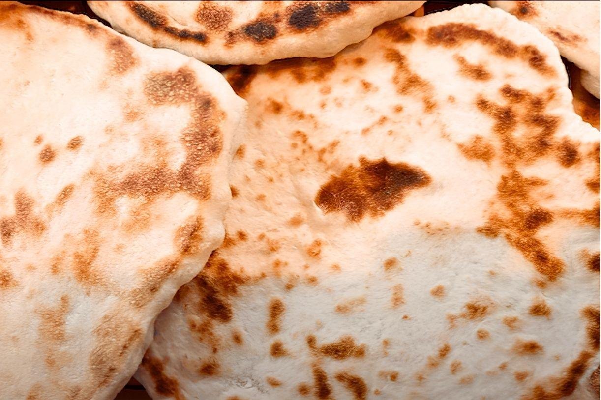 Close up of freshly cooked pitta breads with golden brown blisters