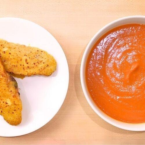 plate of golden brown rarebit and a bowl of hot tomato soup