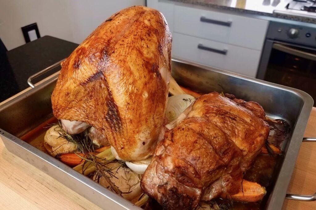 Golden roast turkey crown and rolled turkey joint in a roasting tin