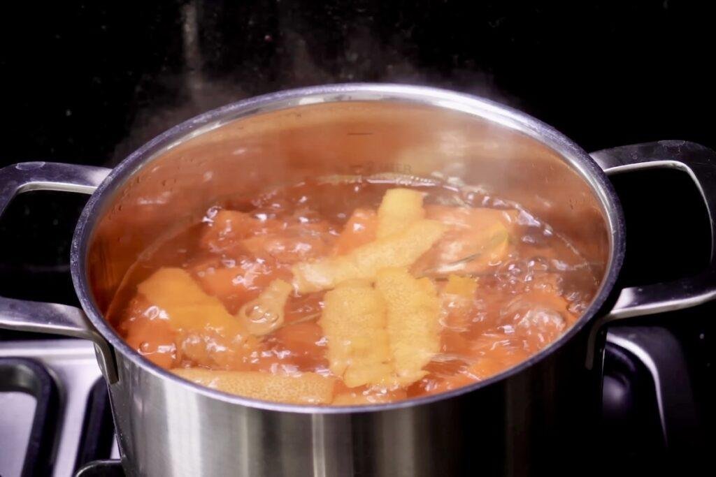 Carrot pieces boiling in a steaming stainless steel pot