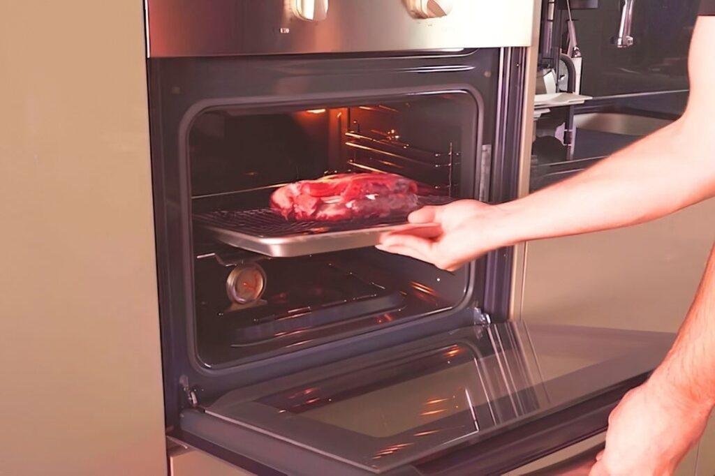 steak going into oven to reverse sear