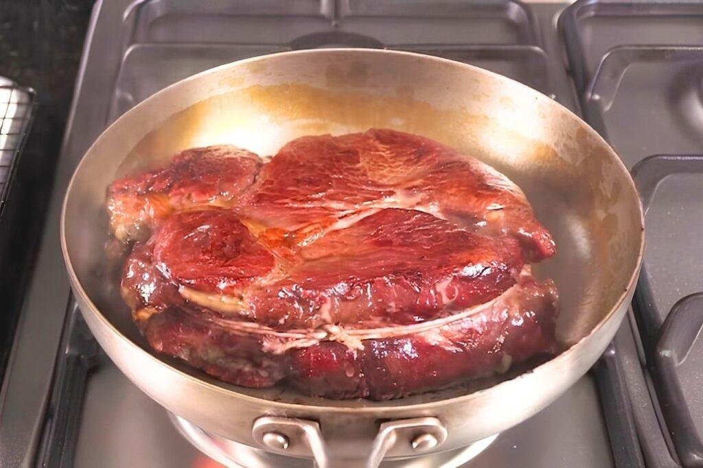 steak frying in a pan