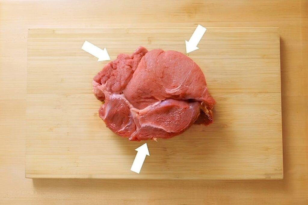 showing 3 sections of the chuck steak naturally connected together