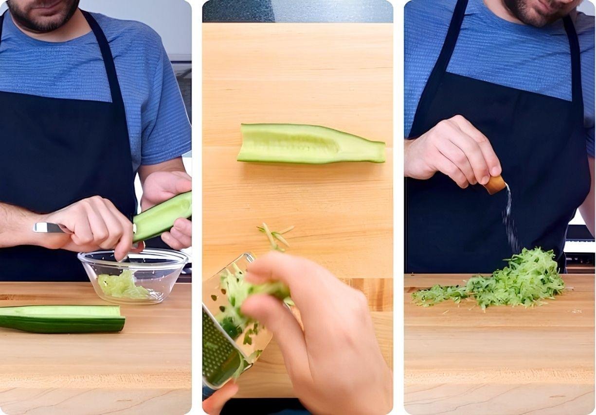 Chopping cucumber and grating garlic for a fresh tzatziki recipe preparation on a wooden countertop.