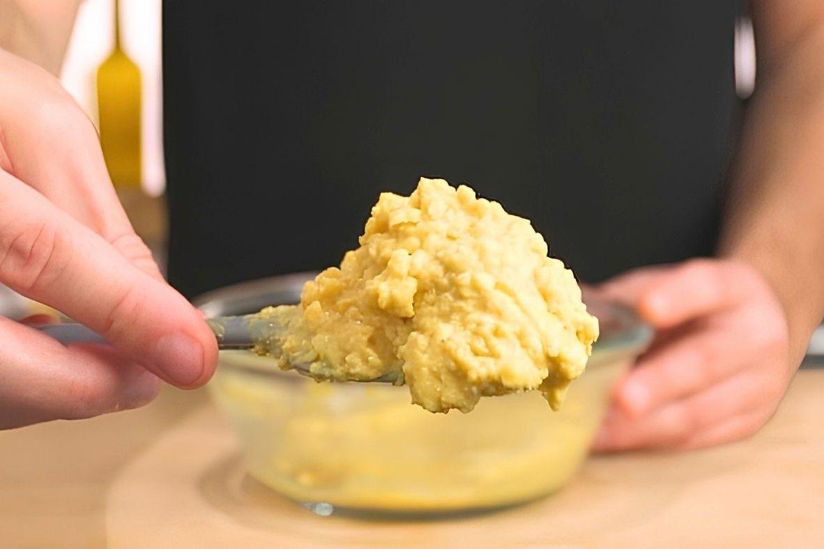 spoon with rarebit mixture on showing the consistency